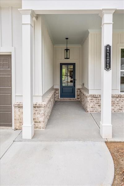 doorway to property with stone siding and board and batten siding