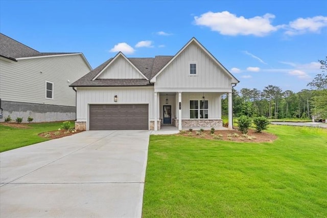 modern farmhouse featuring covered porch, board and batten siding, a front yard, a garage, and driveway