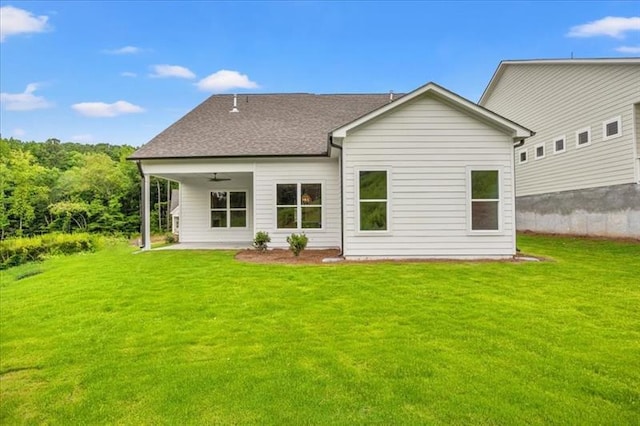 back of property with a patio area, ceiling fan, and a yard