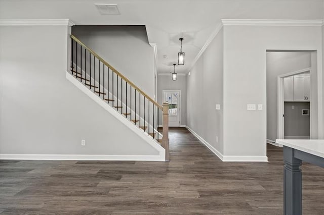 entrance foyer with visible vents, baseboards, stairs, dark wood-style floors, and crown molding