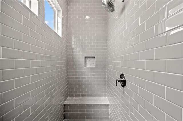 bathroom with tiled shower