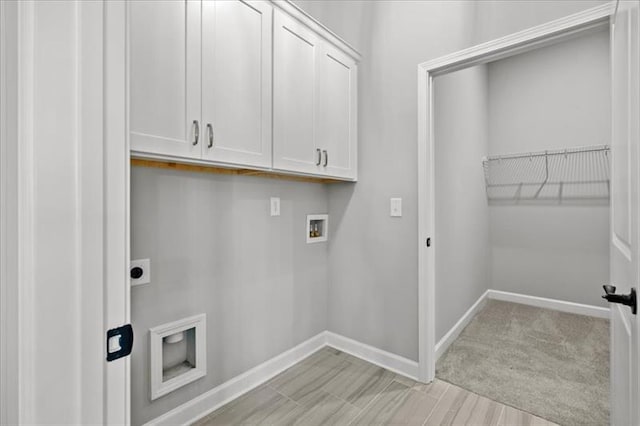 laundry area featuring washer hookup, cabinet space, electric dryer hookup, and baseboards