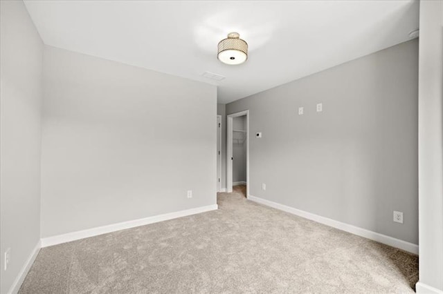 unfurnished room featuring baseboards and carpet flooring