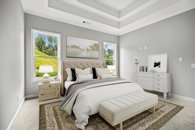 bedroom with light carpet, a raised ceiling, visible vents, and baseboards