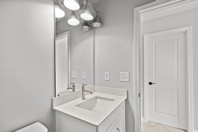 bathroom with toilet and vanity