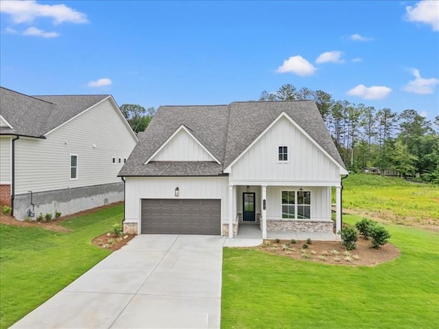 modern inspired farmhouse with a porch, an attached garage, concrete driveway, roof with shingles, and a front lawn