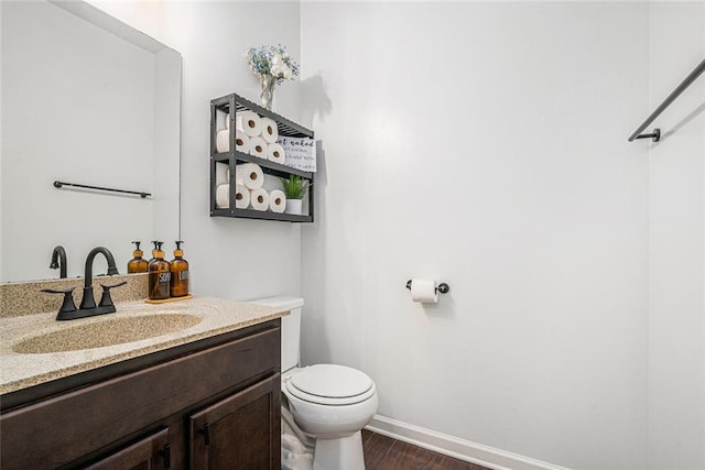 bathroom with vanity, hardwood / wood-style flooring, and toilet