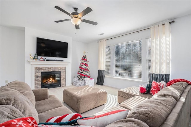 living room with carpet flooring, a brick fireplace, and ceiling fan