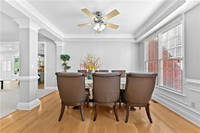 dining room featuring decorative columns, a wealth of natural light, crown molding, and ceiling fan