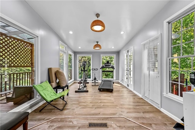 sunroom featuring french doors and lofted ceiling