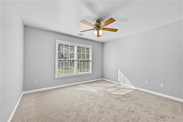 carpeted empty room with ceiling fan