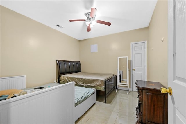 tiled bedroom featuring ceiling fan