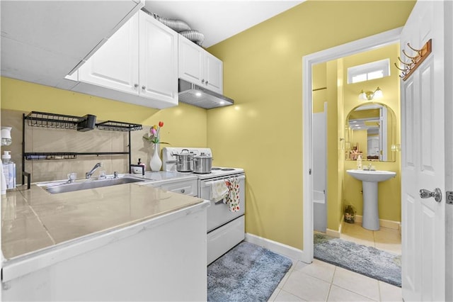 clothes washing area with light tile patterned floors and sink