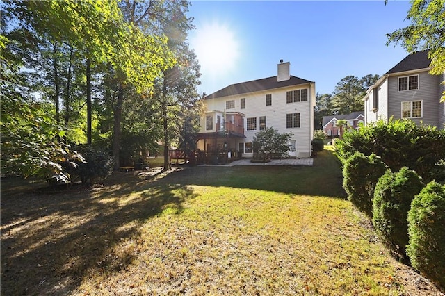 rear view of house featuring a yard