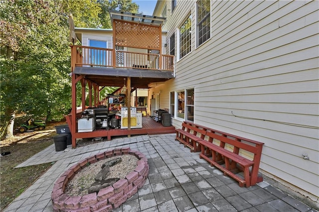 view of patio / terrace with an outdoor fire pit and a wooden deck