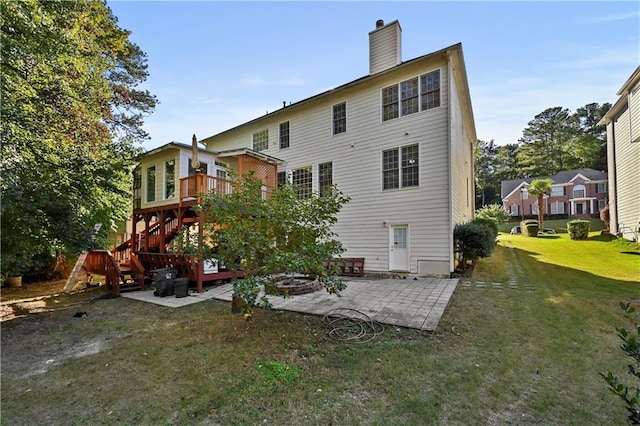 rear view of property featuring a yard and a patio