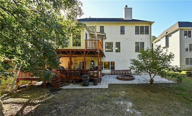 back of house with an outdoor fire pit, a patio area, and a wooden deck