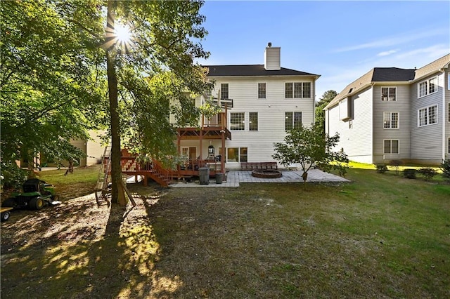 rear view of property with a lawn, a patio area, and a deck