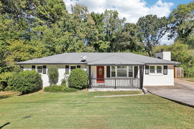 ranch-style home with a front yard and covered porch