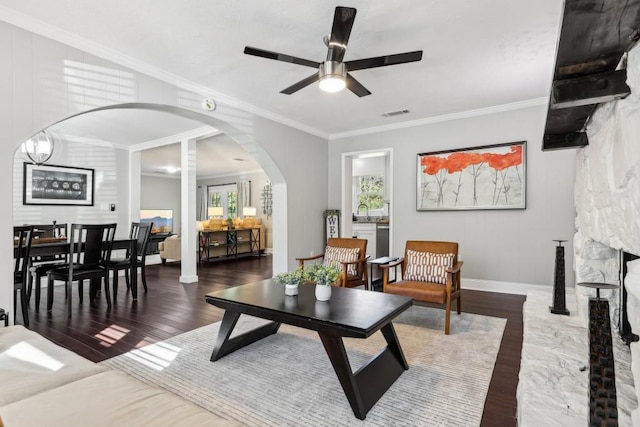 living room featuring crown molding, dark hardwood / wood-style floors, and ceiling fan