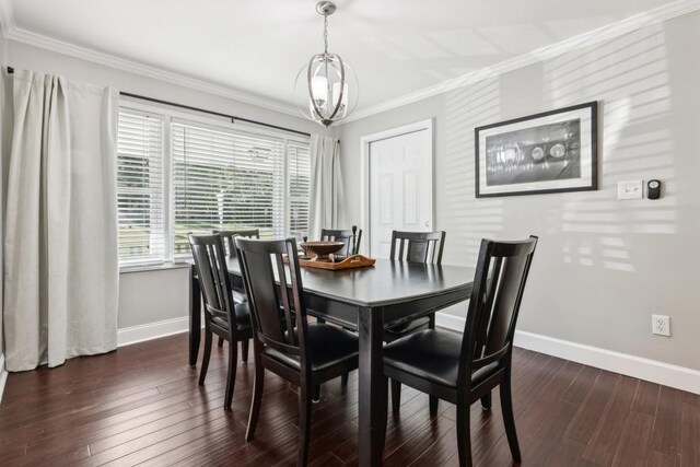 dining room with crown molding, a notable chandelier, and dark wood-type flooring