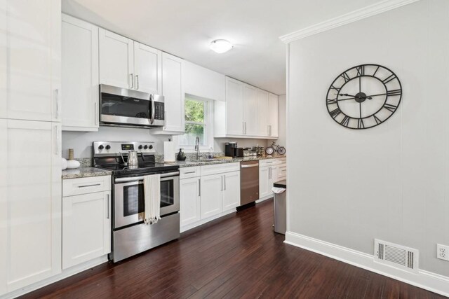 kitchen featuring white cabinetry, light stone counters, appliances with stainless steel finishes, and dark hardwood / wood-style flooring