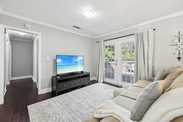 living room with french doors, crown molding, and dark hardwood / wood-style flooring