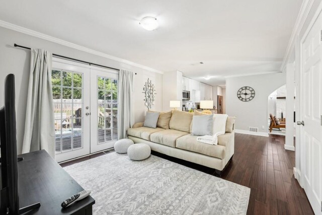 living room with french doors, crown molding, and dark hardwood / wood-style flooring