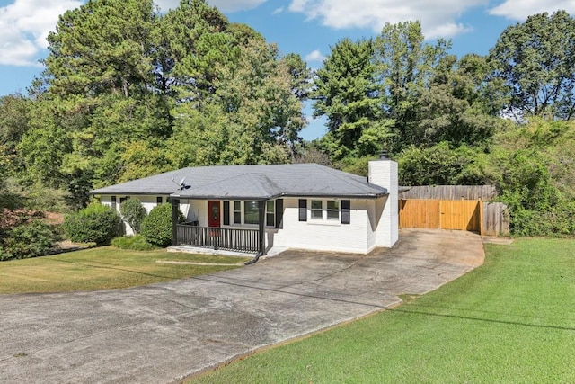 single story home with covered porch and a front lawn