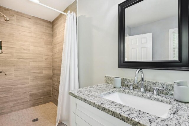 bathroom with vanity and a shower with shower curtain