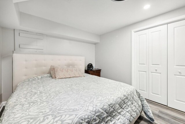 bedroom featuring light hardwood / wood-style flooring and a closet