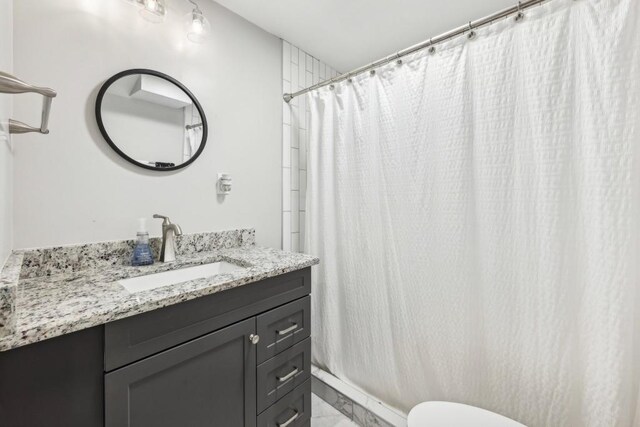 bathroom featuring vanity, a shower with curtain, and toilet