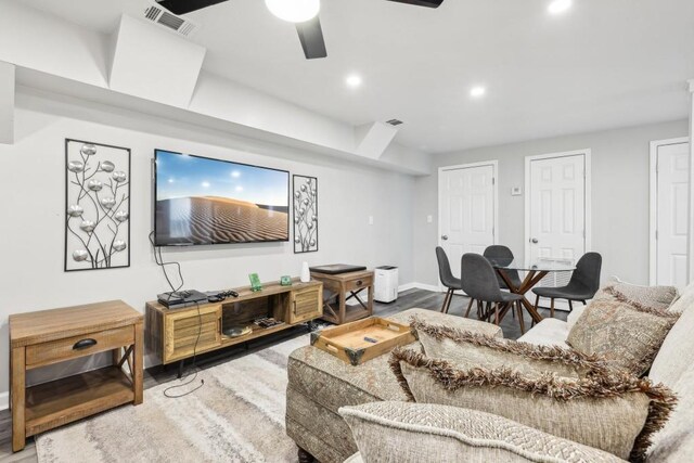 living room featuring ceiling fan and hardwood / wood-style floors