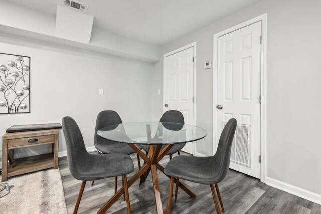 dining room with dark hardwood / wood-style flooring