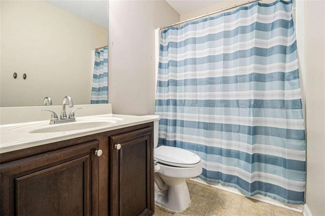 bathroom with toilet, vanity, a shower with curtain, and tile patterned flooring