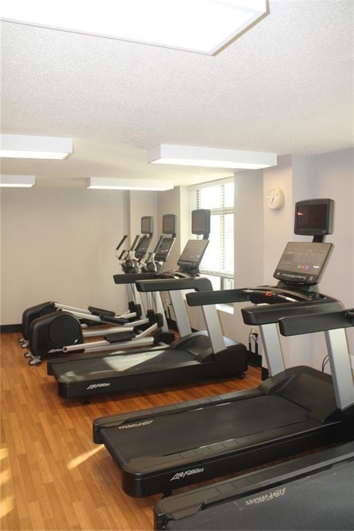 250 Park Ave W Unit 802, Atlanta, GA 30313 - workout area featuring a textured ceiling and wood finished floors