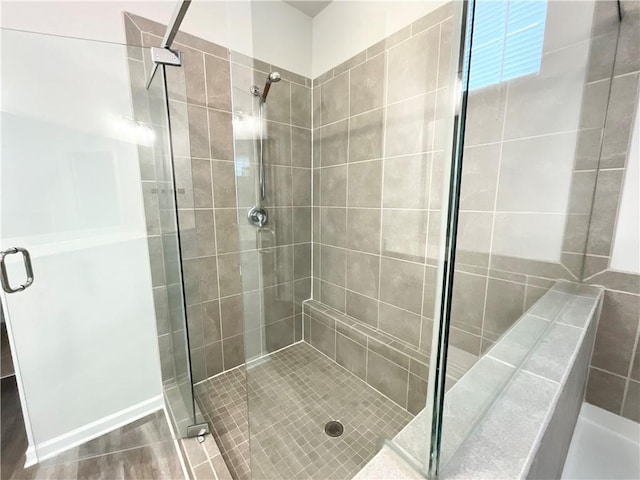 bathroom with hardwood / wood-style floors and walk in shower