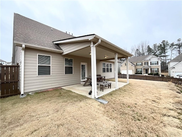 back of house featuring a patio and a lawn