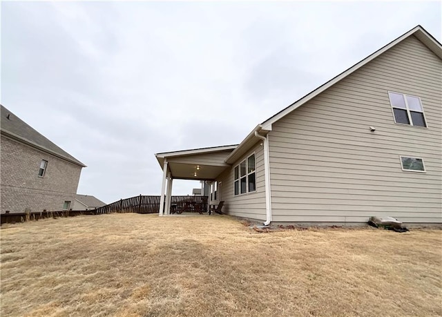 view of side of home featuring a lawn