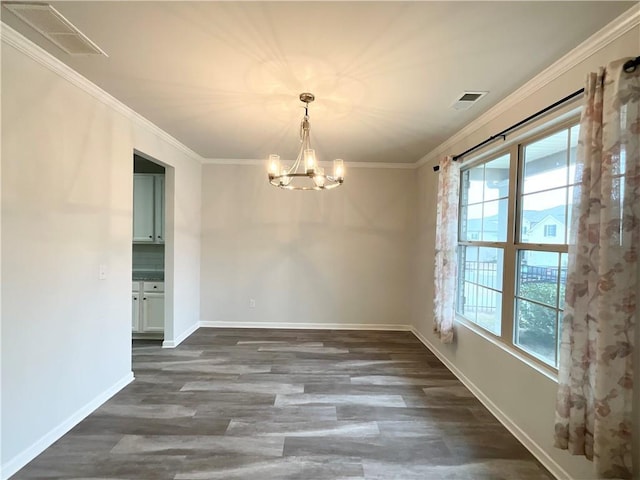 unfurnished dining area with crown molding, dark wood-type flooring, and a chandelier