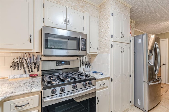 7234 Post Rd, Winston, GA 30187 - kitchen with stainless steel appliances, white cabinets, tasteful backsplash, ornamental molding, and light tile patterned flooring