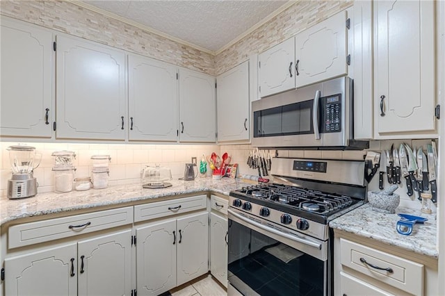 7234 Post Rd, Winston, GA 30187 - kitchen featuring stainless steel appliances, ornamental molding, tasteful backsplash, and white cabinetry