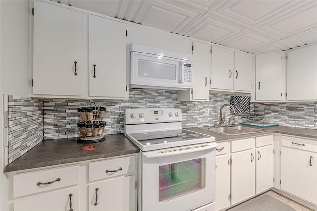 7234 Post Rd, Winston, GA 30187 - kitchen with white appliances, decorative backsplash, white cabinets, and dark countertops