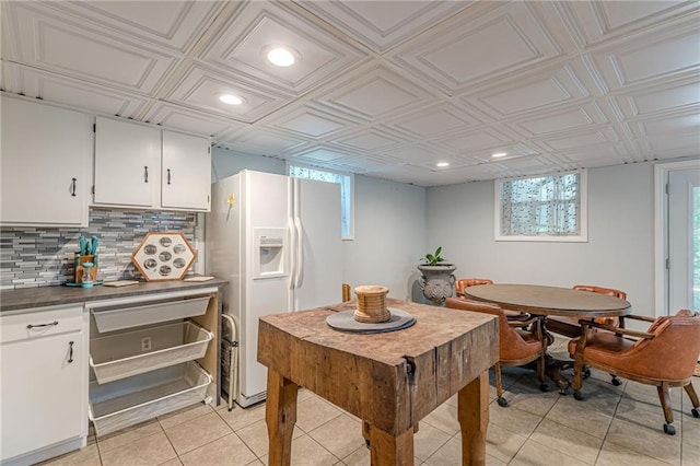 7234 Post Rd, Winston, GA 30187 - kitchen with white fridge with ice dispenser, light tile patterned floors, plenty of natural light, recessed lighting, and tasteful backsplash