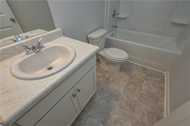 full bathroom featuring shower / washtub combination, vanity, and toilet