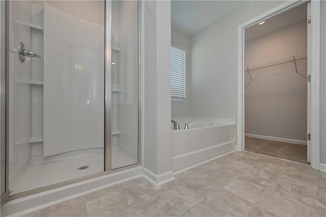 bathroom featuring independent shower and bath