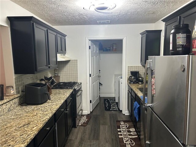 122 Sterling Ct Unit 122, Alpharetta, GA 30004 - kitchen with appliances with stainless steel finishes, under cabinet range hood, dark wood-style floors, a textured ceiling, and light stone counters