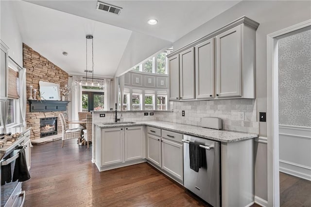 217 Springs Xing, Canton, GA 30114 - kitchen featuring appliances with stainless steel finishes, healthy amount of natural light, a peninsula, dark wood finished floors, and lofted ceiling