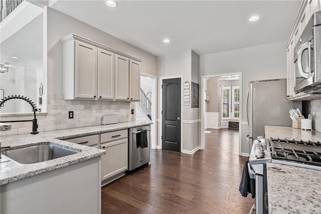 217 Springs Xing, Canton, GA 30114 - kitchen featuring stainless steel appliances, dark wood-style floors, decorative backsplash, light stone countertops, and wainscoting