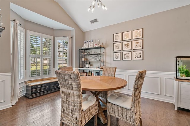 217 Springs Xing, Canton, GA 30114 - dining space with vaulted ceiling, wood finished floors, a decorative wall, wainscoting, and a chandelier